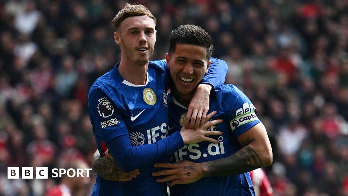 Two players celebrating a goal on the pitch