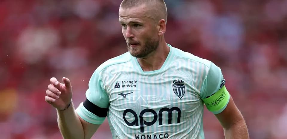 Player in mint jersey with captain's armband during match