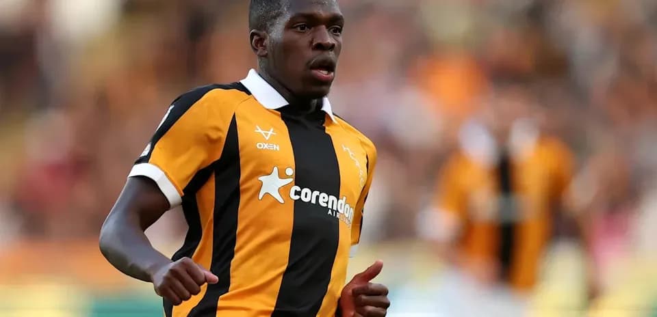 Player running on the pitch in team colors