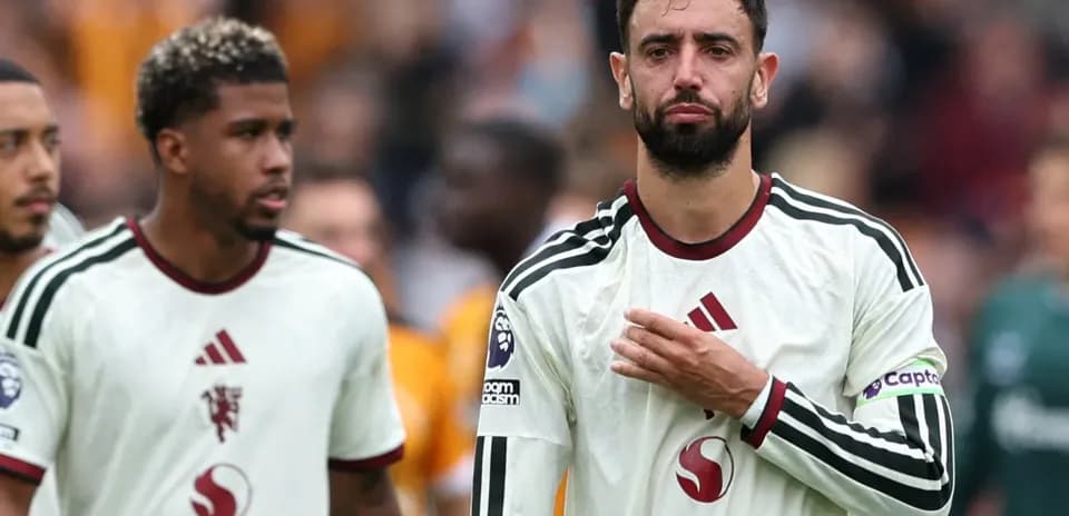 Two players walking off the pitch after match
