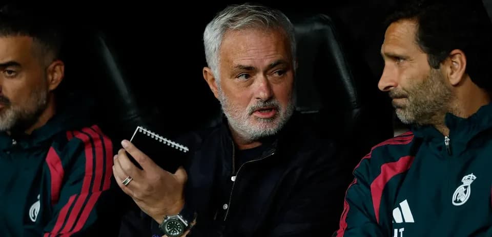 Coaches discussing strategy on the bench during match