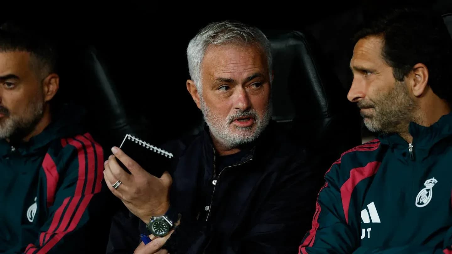 Coaches discussing strategy on the bench during match