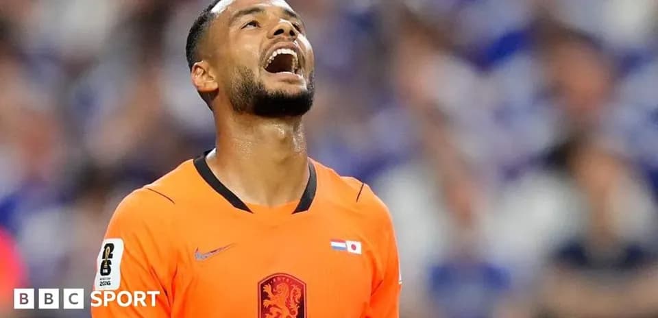 Player in orange kit reacting during a match