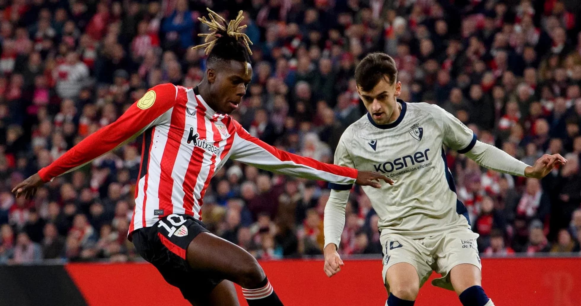 Athletic Club player dribbling against Osasuna opponent