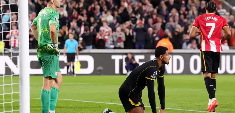 Goalkeeper and player reacting after conceding a goal