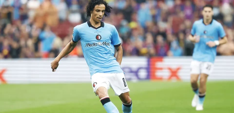 Player in blue kit preparing to pass the ball