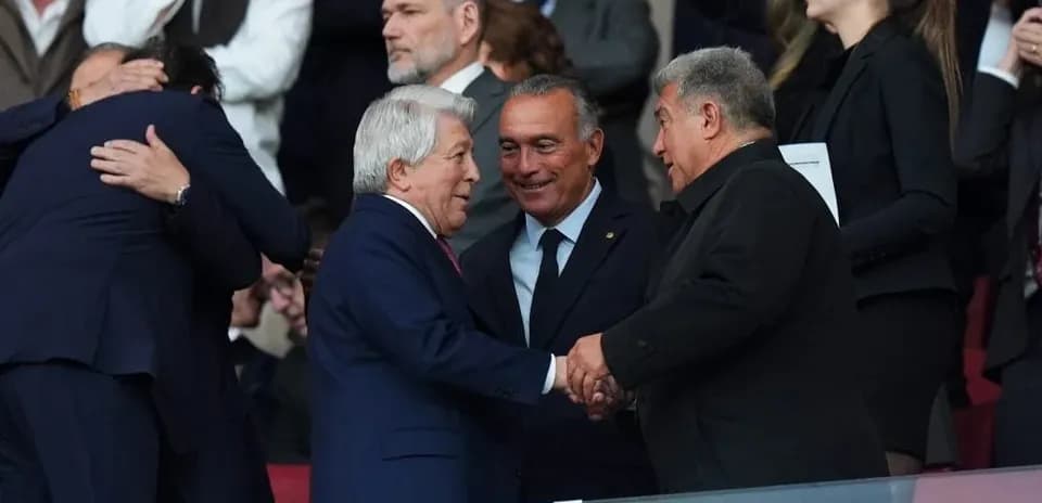 Executives shaking hands in stadium seating area