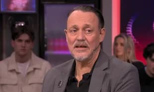 Man speaking during a television interview segment