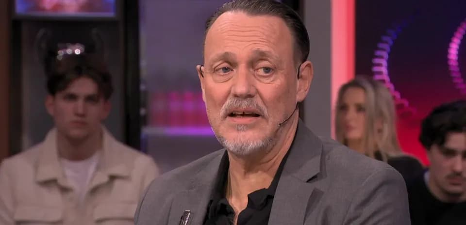 Man speaking during a television interview segment