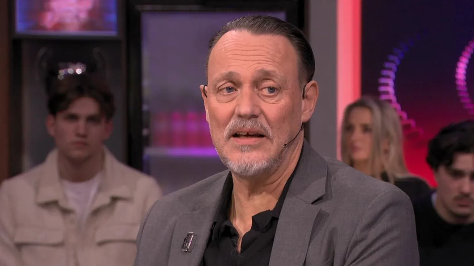 Man speaking during a television interview segment