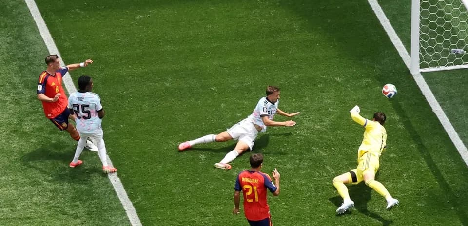 Goalkeeper diving to save a shot on goal