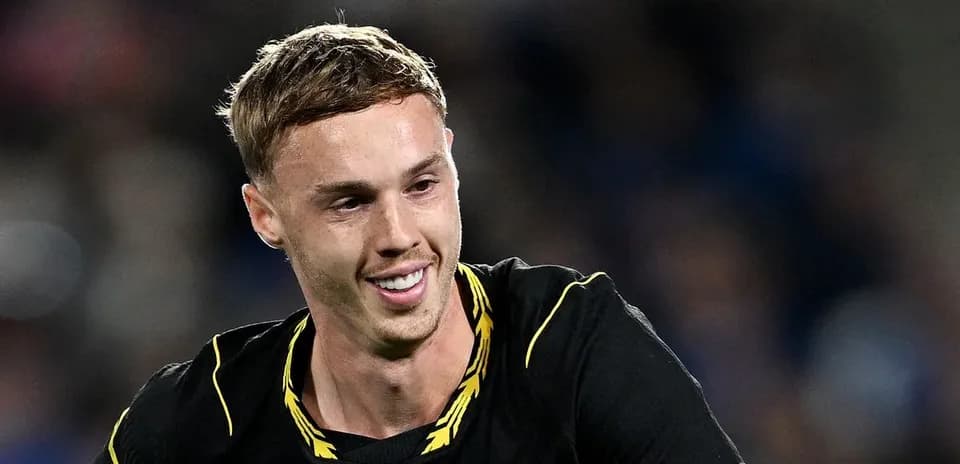 Player smiling during a football match celebration