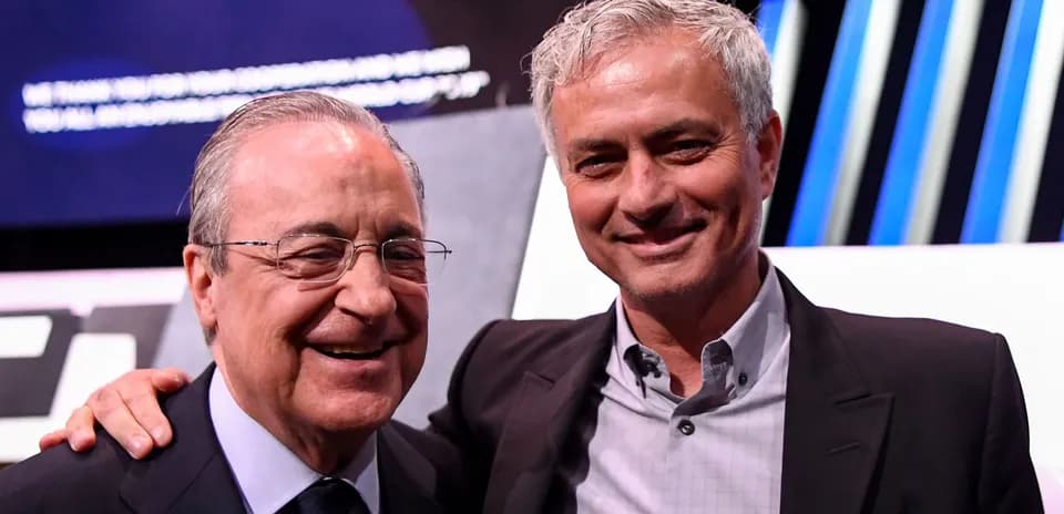 Two men smiling at event, one in suit