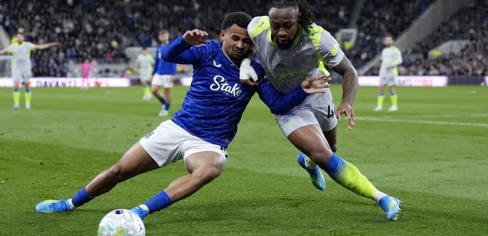 Two players battling for the ball on the pitch