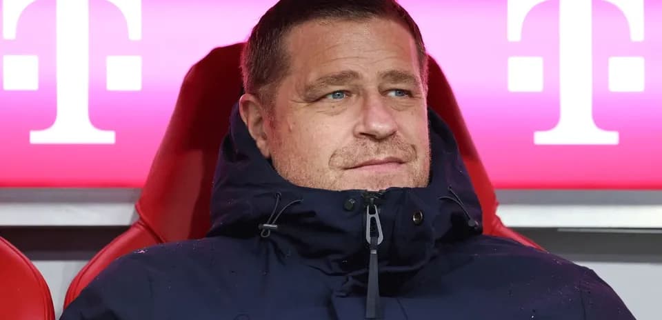 Coach seated on bench during match at stadium