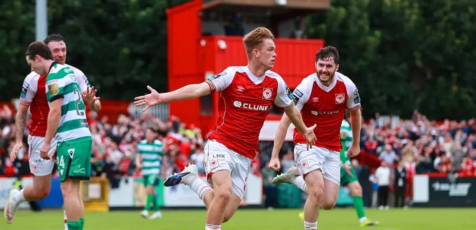 Player celebrating goal with teammates on field