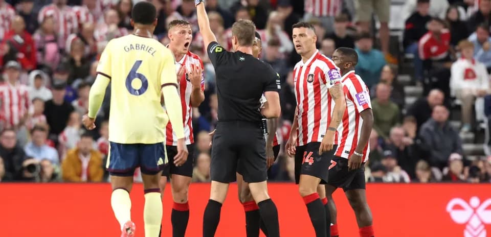 Referee showing yellow card during Sunderland match