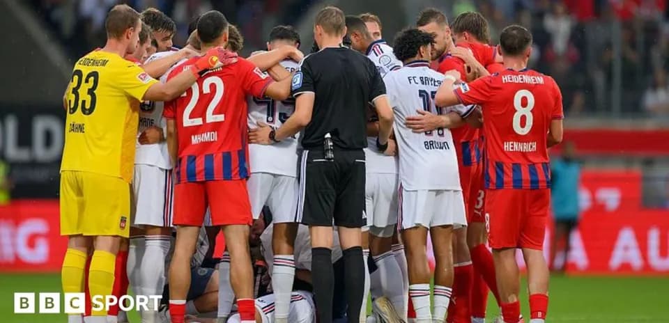 Players from both teams huddled together on field