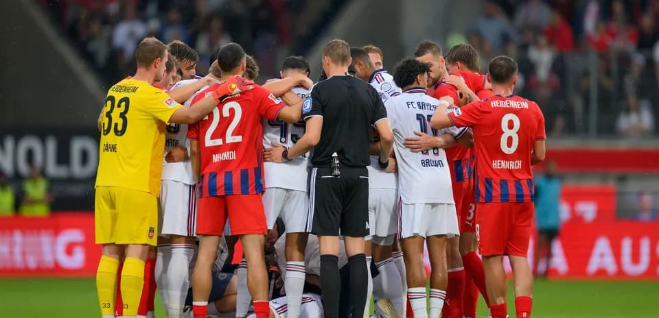 Players from both teams huddled together during match