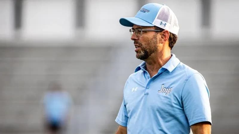 Coach speaking on the sidelines during a game