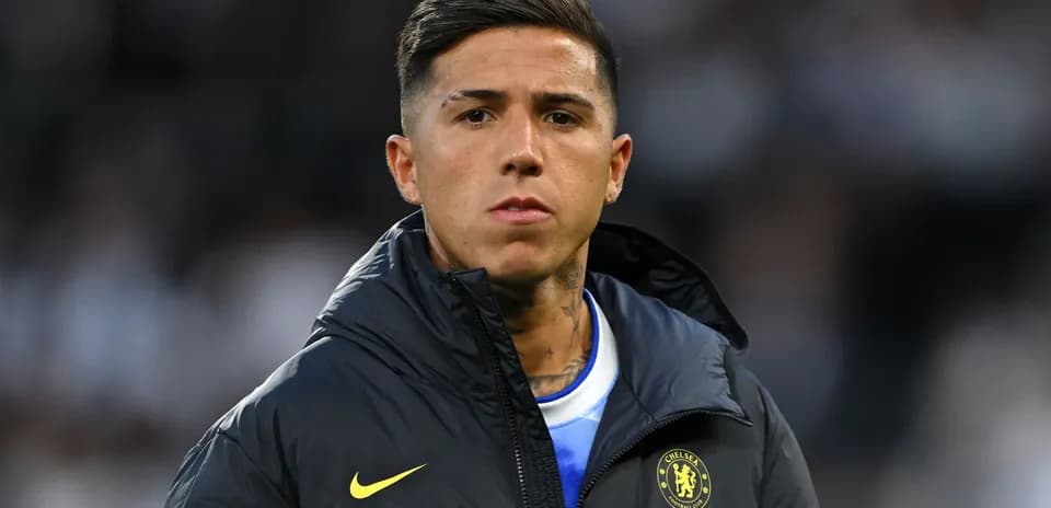 Player in Chelsea jacket on sidelines during match