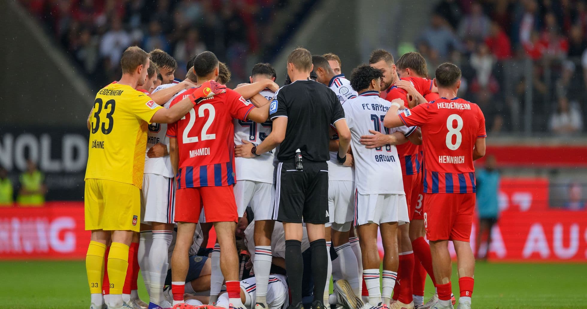 Players from both teams huddled together on field