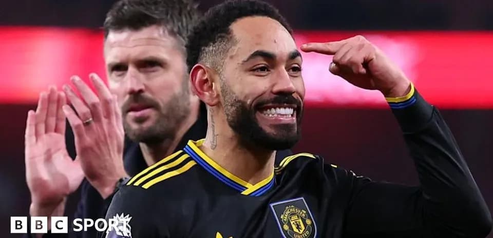 Player celebrating with teammate after scoring goal