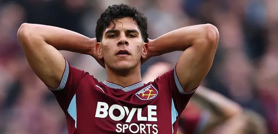 Player in claret jersey with hands on head