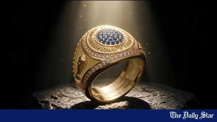 Golden championship ring displayed with spotlight