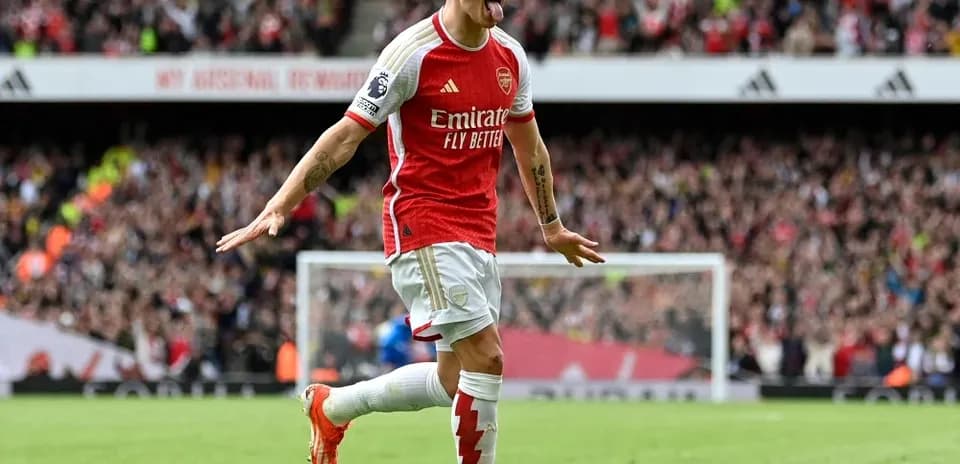 Arsenal player celebrating a goal with fans