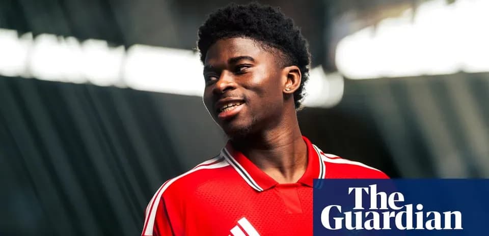 Player in red jersey smiling for photo