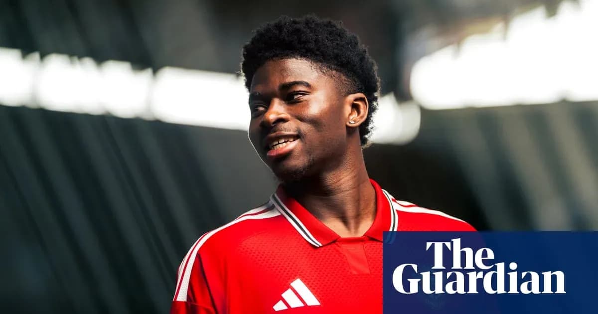 Player in red jersey smiling for photo