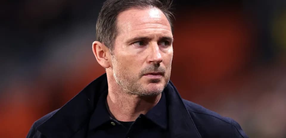 Football manager walking on the pitch sidelines