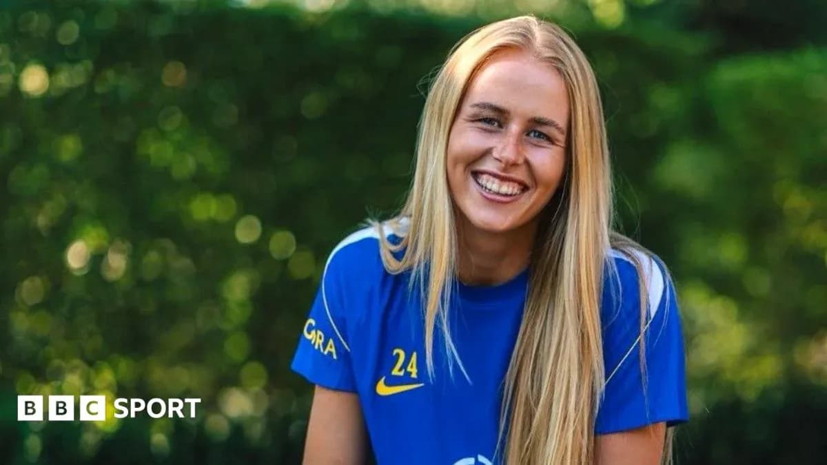 Player smiling in blue jersey outdoors