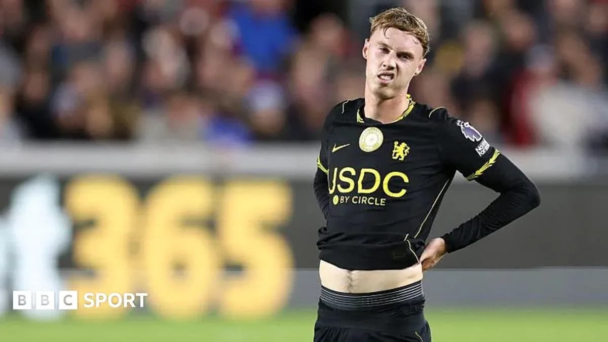 Player in black jersey showing signs of discomfort