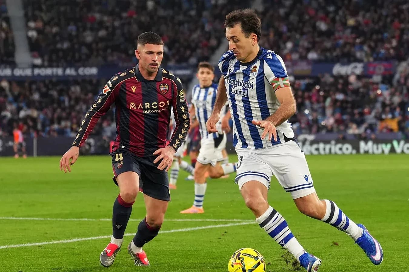 Real Sociedad player dribbling past Levante defender