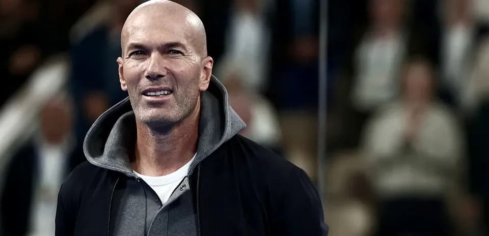 Man in a hoodie smiling at an event