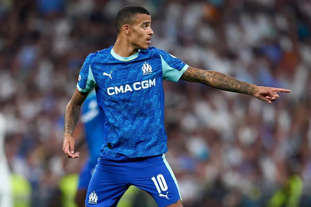 Player in Marseille kit directing teammates on field