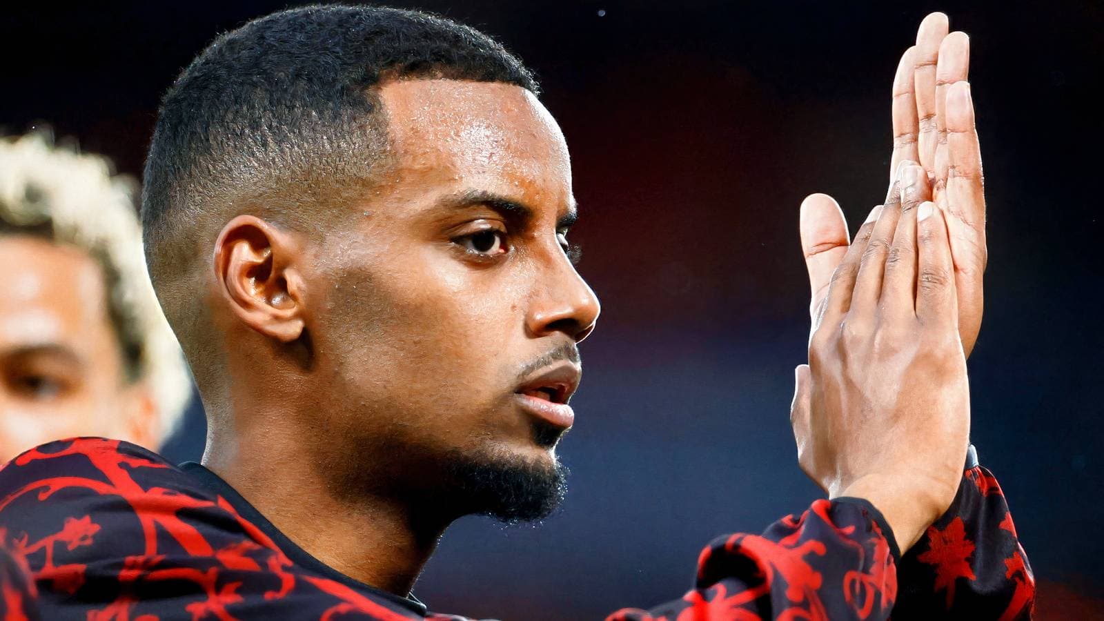 Player applauding while wearing team jersey