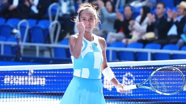 Tennis player celebrating with racket on court