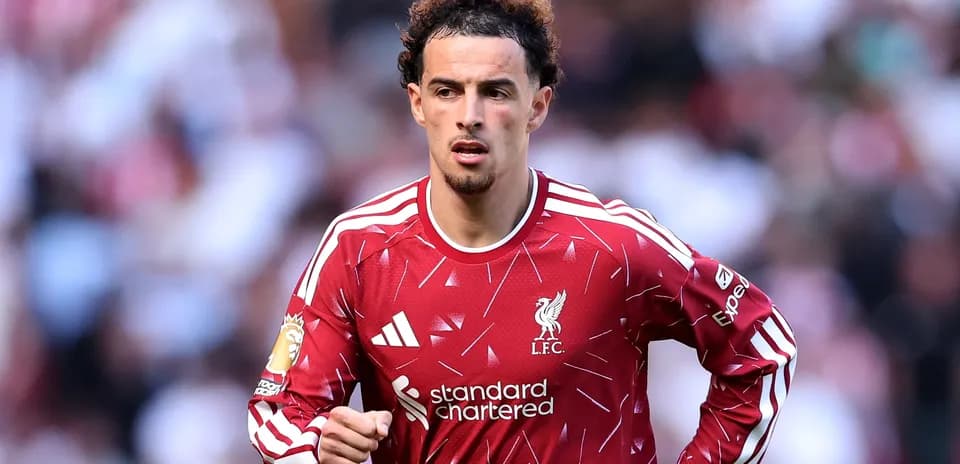 Player in Liverpool jersey running on the pitch