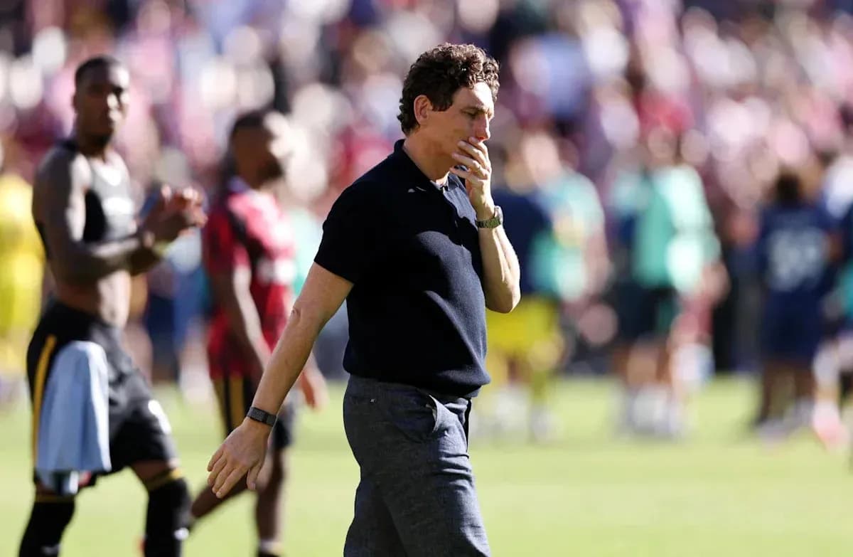 Coach walking past players after match conclusion