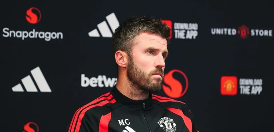 Manager speaking at press conference with logo backdrop