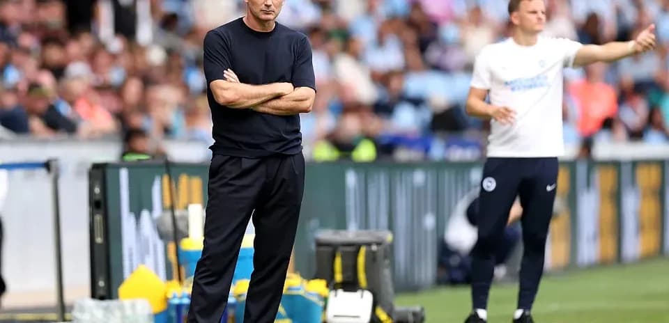 Two coaches on the sidelines during a match
