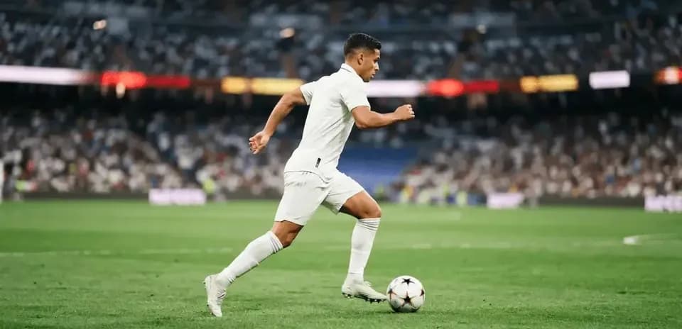 Player running with the ball on the pitch