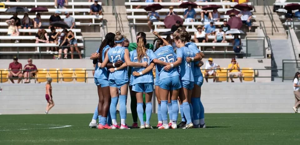 Team huddled together before the match on field