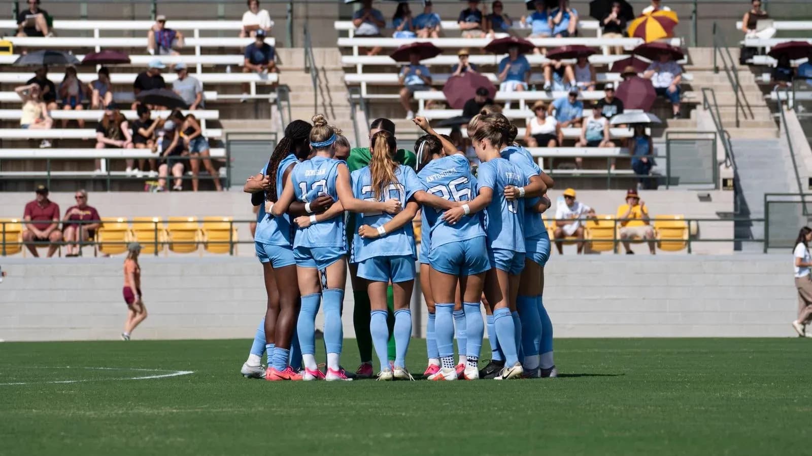 Team huddled together before the match on field