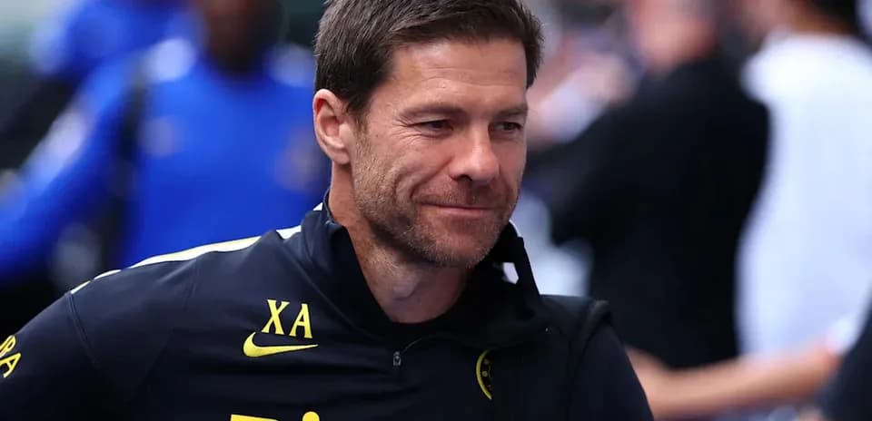 Coach smiling while arriving at training facility