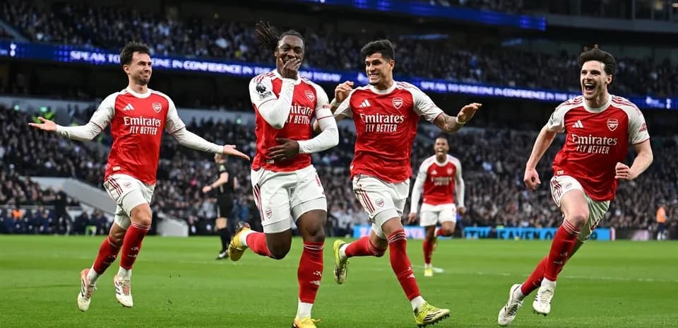 Arsenal players celebrating a goal on the pitch