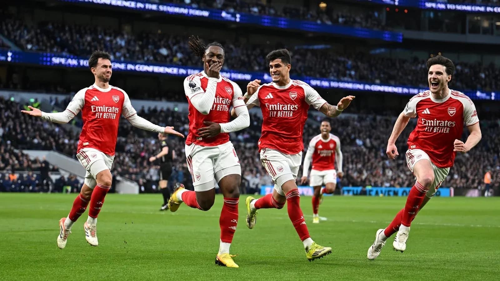Arsenal players celebrating a goal on the pitch